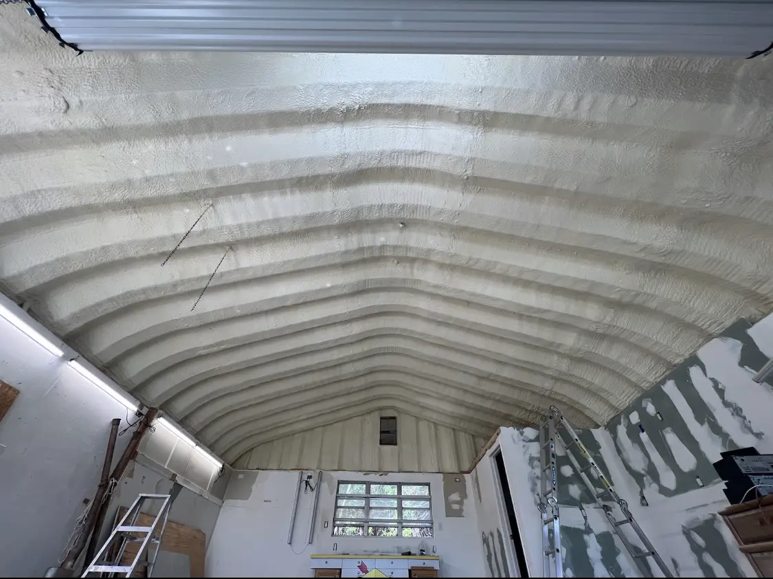 Spray polyurethane foam applied to the underside of a metal roof deck in Kenner